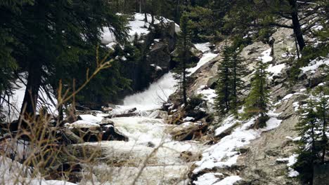 Slow-motion-waterfall-flowing-off-Lost-Lake-into-a-river-in-the-Rocky-Mountains-of-Colorado,-wide-shot