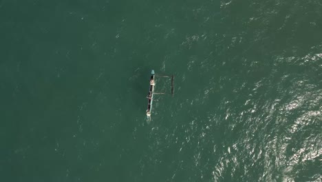 Aerial-Drone-Shot-of-Fishermen-in-a-Traditional-African-Fishing-Canoe