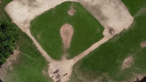 A-Boom-shot-of-a-baseball-field-in-the-dominican-republic-with-kids-playing-in-the-home-base