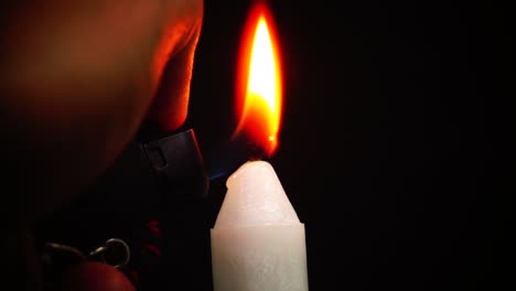 A-candle-lit-by-a-gas-lighter