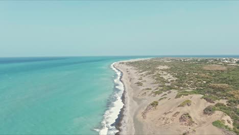 Aerial-view-flying-along-the-coastline-of-Dunes-of-Bani-in-Dominican-Republic---reverse,-drone-shot