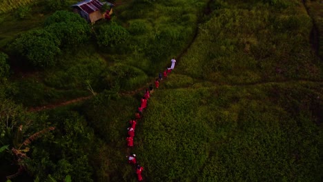 Aerial-shot-of-Tribal-people-walking-towards-the-mountain