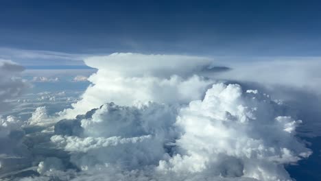 Unique-view-from-a-jet-cockpit-at-cruise-level-of-two-huge-cumulominmus-ahead