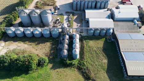 Dolly-left-aerial-shot-of-large-silos-on-an-industrial-plant