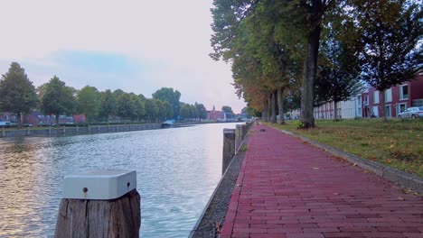 Low-angle-pan-over-quay-waterside-and-pavement-at-blue-hour-in-s-hertogenbosch