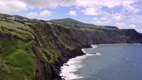 Massive-rugged-sea-cliffs-on-atlantic-coastline-of-Azores,-flyover