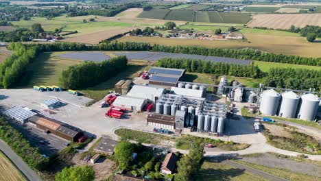 Dolly-right-view-from-a-drone-of-a-industrial-processing-plant-in-Kent-countryside-with-silos