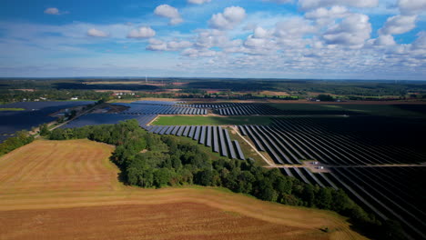 Aerial-shot-of-huge-solar-farm-in-colorful-countryside-fields-in-summer