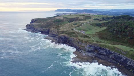 Drone-capture-the-aerial-view-of-the-green-Isla-island-and-blue-Cantabrian-sea-from-a-great-height