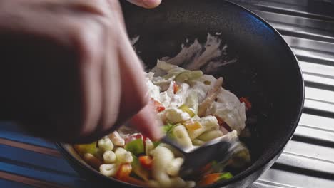 Mixing-Fileja-Pasta-In-A-Bowl-With-Chopped-Bell-Pepper,-Mayonnaise,-And-Seasonings