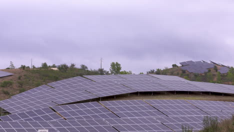Close-up-shot-of-a-field-with-solar-panels-that-cover-a-whole-hill