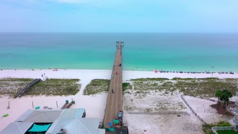 Drone-aerial-view-flying-down-the-Navarre-Beach-Florida-pier-going-into-the-Gulf-of-Mexico