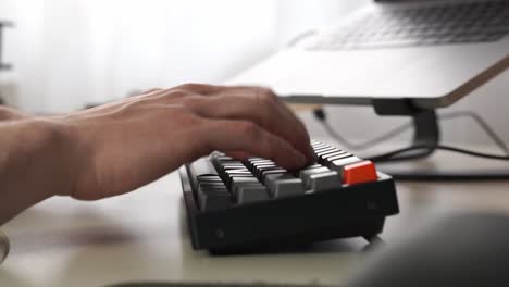 Male-hands-start-to-type-at-a-fictitiously-high-rate-of-speed-on-a-wireless-computer-keyboard