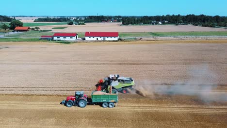 Aerial-Shot-of-Combine-Loading-Off-Corn-Grains-Into-Tractor-Trailer-4