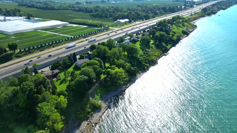 Aerial-view-Queen-Elizabeth-Way-road-next-to-Lake-Ontario-in-Canada