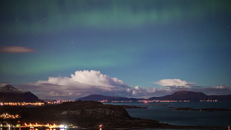 Green-aurora-borealis-and-changing-clouds-time-lapse-over-Alesund,-Norway