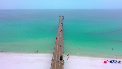 Aerial-view-flying-slowly-down-the-Navarre-Beach-FL-pier
