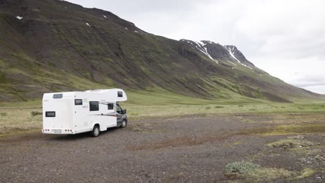Recreational-vehicle-in-the-mountains-of-Iceland-with-gimbal-video-walking-from-behind
