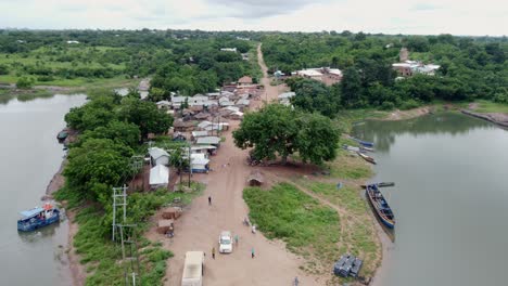 Aerial-Dolly-In-Shot-of-Small-Fishing-Village-by-Lake-in-Ghana-West-Africa