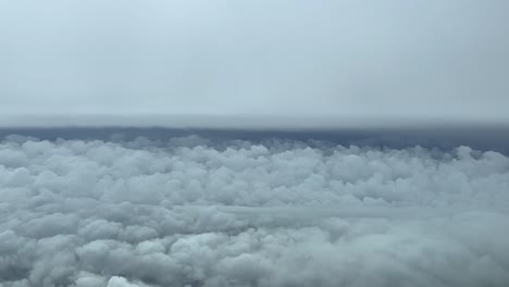 Amazing-view-fom-a-jet-cockpit,-pilot-point-of-view,-while-flying-through-a-turbulent-sky-with-layers-of-clouds