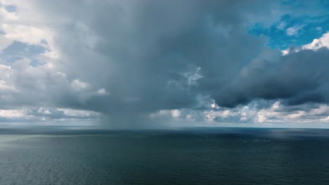 Beautiful-Aerial-Drone-Shot-of-Huge-Rain-Cloud-Raining-over-the-Ocean
