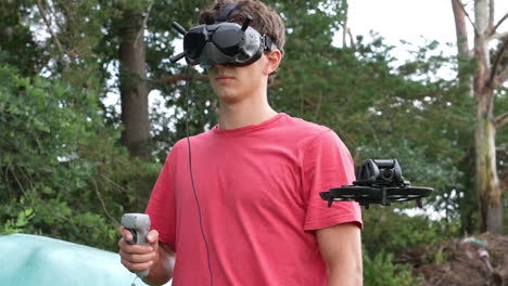 Young-Man-Controlling-FPV-Drone-With-Motion-Remote-Controller-and-Goggles-Headset