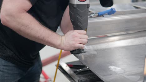 Man's-Hands-Using-Reciprocating-Saw-at-Workshop-to-Cut-Metal-Plate