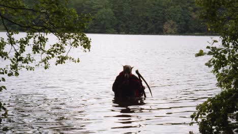 Dog-Skull-Grim-Reaper-With-Scythe-walks-out-From-The-Water-In-The-Lake