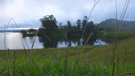 Time-Lapse-Guatape-Lake-in-Medellin-Colombia-Morning-Fog-Early-Haze-Above-Water-Evaporation-Surface-Daytime-Haze-Clouds-passing-by