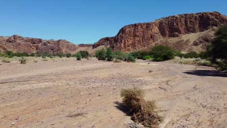 Scenic-landscape-of-a-dry-riverbed-and-mountain-wilderness-of-northern-Namibia
