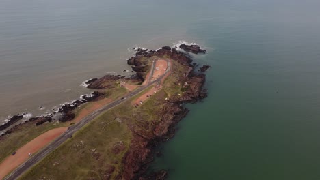 Aerial-view-of-tourist-in-car-arriving-punta-ballena-viewpoint-area-in-Uruguay