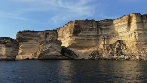 Fpv-panning-of-Bonifacio-Corse-town-built-on-high-cliff-seen-from-sailing-boat-along-Corsica-coast-in-France