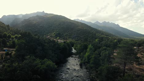 Slow-flight-between-the-trees-and-following-a-river-in-Corsica