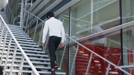 Demotivated-banker-walking-up-office-stairs
