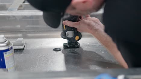 Man-Worker-Cutting-Aluminum-Metal-Using-Reciprocating-Saw-at-Workshop---close-up-slow-motion