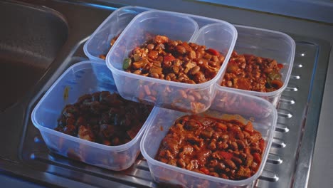 Cooked-Spicy-Chicken-Beans-Divided-Into-Five-Containers-For-Storing