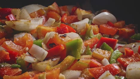 Sprinkling-Salt-To-Bell-Peppers-And-Onions-Sauteing-In-A-Skillet