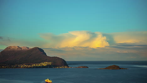 Amazing-bright-dramatic-sky-in-warm-colours-above-Alesund-Valderoya-and-Islands-at-sunrise-in-timelapse