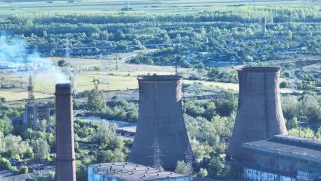 Hyperboloid-Cooling-Towers-And-Chimney-Releasing-White-Smoke-At-Daytime-In-Galati,-Romania