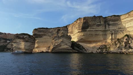 Fpv-panning-of-Bonifacio-Corse-town-built-on-high-cliff-seen-from-sailing-boat-along-Corsica-coast-in-France-1