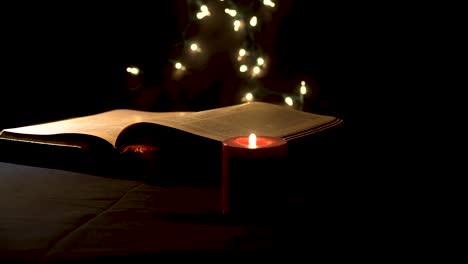 Holy-book-with-burning-candle-in-mystical-environment