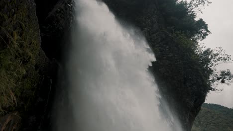 Powerful-Water-Cascade-Of-Devil's-Cauldron-In-Baños-de-Agua-Santa,-Ecuador---low-angle