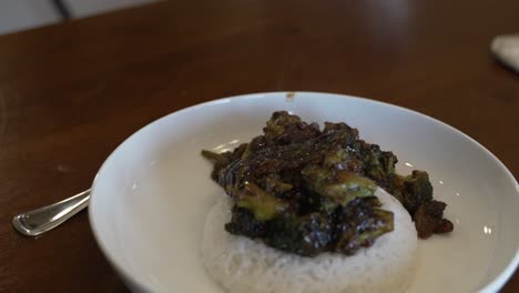 A-steaming-hot-plate-of-broccoli-and-beef-stir-fry-on-a-bed-of-sticky-rice