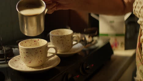 Pouring-Tea-into-Ceramic-Cups-Inside-a-Kitchen