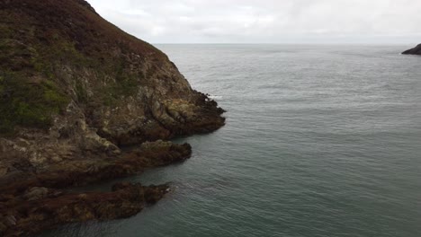 Beautiful-Rock-Formation-In-Quiet-Water,-Traeth-Porth-Wen,-United-Kingdom