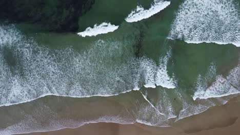The-waves-on-the-beach-of-La-Palue-in-Brittany-in-France,-filmed-with-the-drone-from-above