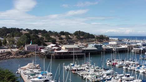 Low-push-in-aerial-shot-of-the-Old-Fisherman's-Wharf-in-Monterey,-California