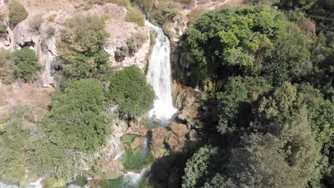 Aerial-Tilt-up-view-of-waterfall-in-the-region-of-Lagunas-de-Ruidera,-between-Albacete-and-Ciudad-Real-in-Spain