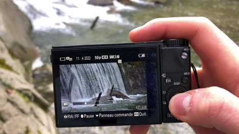 Waterfall-on-the-screen-of-a-compact-camera-in-nature,-outdoor-filmmaking