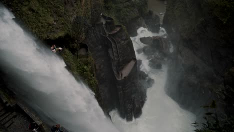 Tourists-Visiting-The-Devil's-Cauldron-Waterfall-In-Baños-de-Agua-Santa,-Ecuador---drone